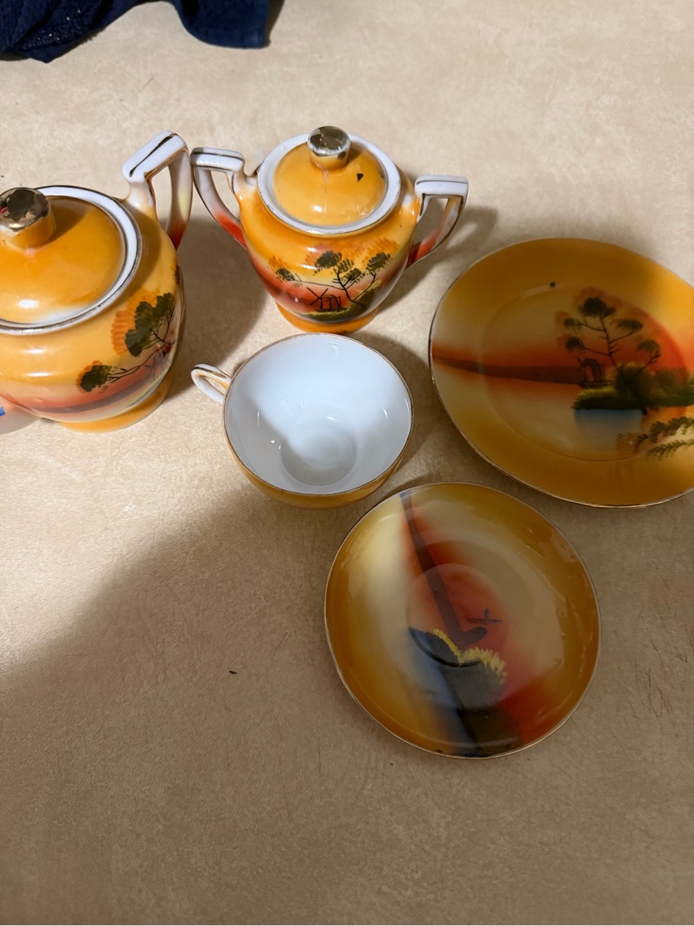 Hand-Painted Orange Porcelain Tea Service with Scenic Motif
